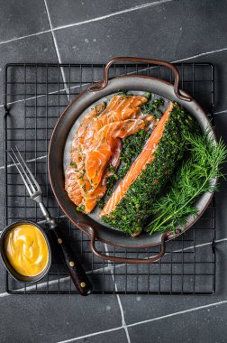 Pickled Salmon fillet with dill, salt and papper, gravlax. Black background. Top view.