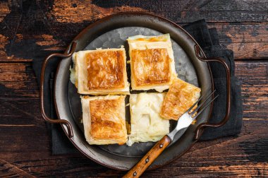 Turkish Su Boregi, Tabla borek or Adana Borek with cheese. Wooden background. Top view.