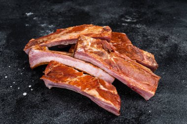 Sliced Smoked BBQ Pork Ribs. Black background. Top view.