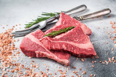 Silverside sirloin beef cut, raw meat on butcher table with herbs. White background. Top view.