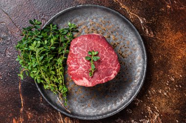 Prime Fillet Mignon Beef steak, Dry aged raw tenderloin meat. Dark background. Top view.