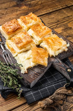Delicious Turkish Tray pastry, Su boregi with cheese. Wooden background. Top view.