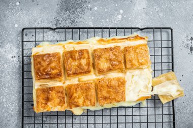Turkish cheese stuffed filo dough borek or Su boregi. Gray background. Top view.