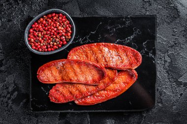 Fried on grill Sucuk beef meat sausage. Black background. Top view.