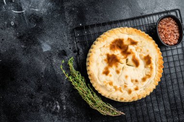 Kubdari Georgian Traditional Flat Bread Filled with Spiced Meat. Black background. Top view. Copy space.