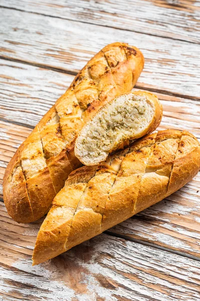 Garlic butter bread, baked baguette with herbs. White background. Top view.