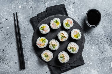 Korean style sushi Kimbap or gimbap made from steamed white rice. Gray background. Top view.