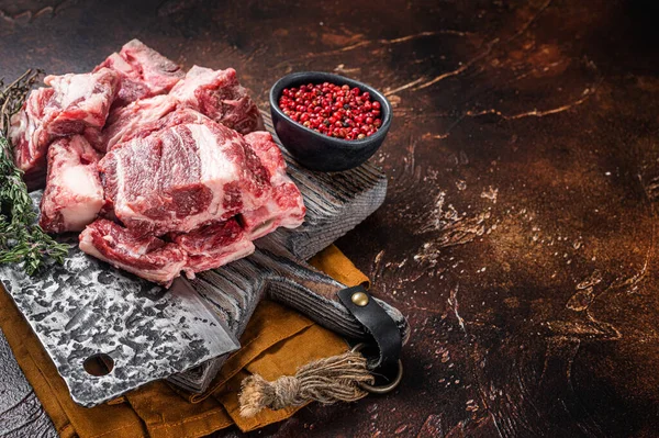 Butcher board with Raw diced beef and lamb meat ready for cooking. Dark background. Top view. Copy space.