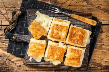 Delicious Turkish Tray pastry, Su boregi with cheese. Wooden background. Top view.