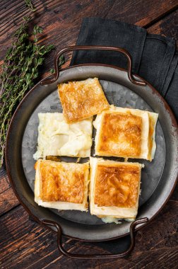 Turkish Su Boregi, Tabla borek or Adana Borek with cheese. Wooden background. Top view.