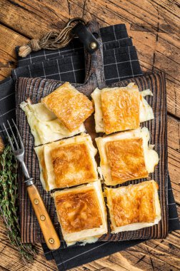 Delicious Turkish Tray pastry, Su boregi with cheese. Wooden background. Top view.