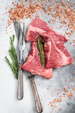 Silverside sirloin beef cut, raw meat on butcher table with herbs. White background. Top view.