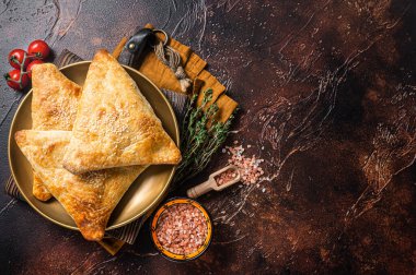 Samsa with chicken and cheese, samosa oriental pies. Dark background. Top view. Copy space.