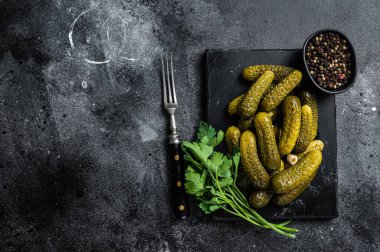 Sarımsak ve baharatlı salatalık turşusu. Siyah arka plan. Üst Manzara. Boşluğu kopyala.