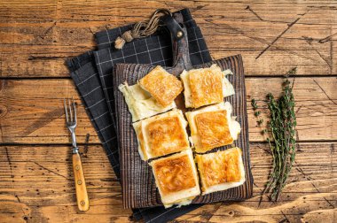 Delicious Turkish Tray pastry, Su boregi with cheese. Wooden background. Top view.