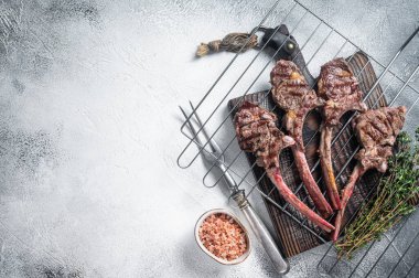 Barbecue grilled lamb meat chop on a grill, mutton rib cutlet. White background. Top view..Copy space.