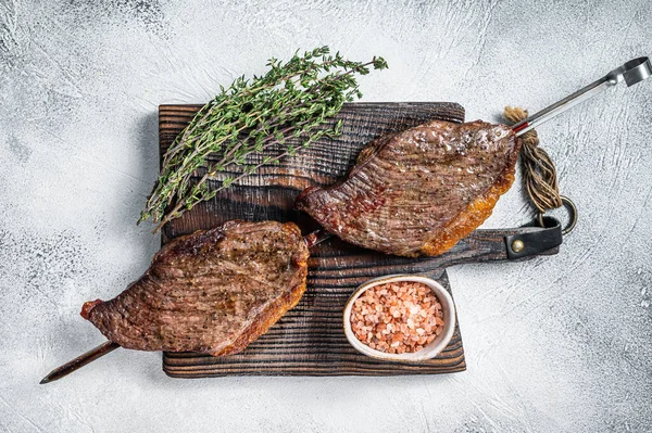 Barbecue grilled dry aged wagyu Brazilian picanha from the sirloin cap beef meat. White background. Top view.