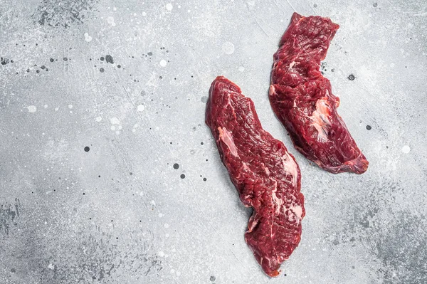 Machete steak raw cut or hanging tender cut. Gray background. Top view. Copy space.