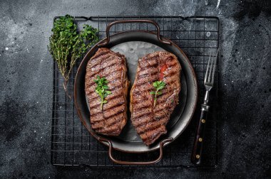 Grilled Top Blade or flat iron beef meat steaks. Black background. Top View.