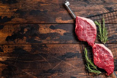 Ready for cooking raw picanha barbecue skewer. Wooden background. Top view. Copy space.