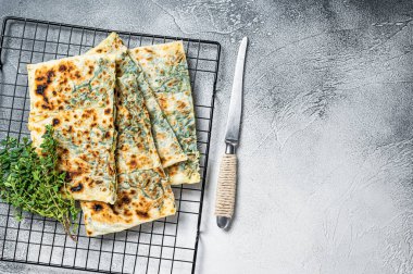 Gozleme Turkish stuffed pastrie, flatbread with greens and cheese. White background. Top view. Copy space.