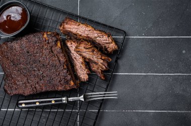 Chopped Beef Brisket barbecue, Traditional meat rubbed with spices and smoked in a Texas smoker. Black background. Top view. Copy space.