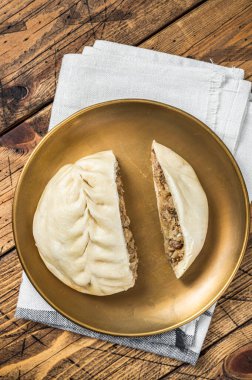 Wang Mandu Pyanse steamed pie stuffed with vegetable and meat Wooden background. Top view.