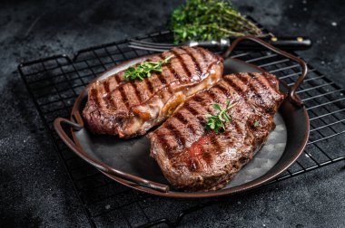 Grilled Top Blade or flat iron beef meat steaks. Black background. Top View.