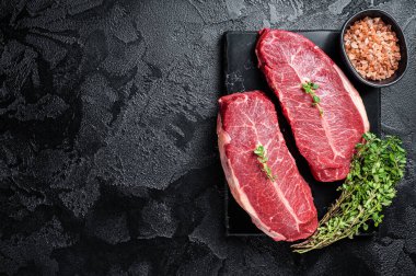 Raw wagyu oyster top blade steaks, organic beef meat. Black background. Top View. Copy space.