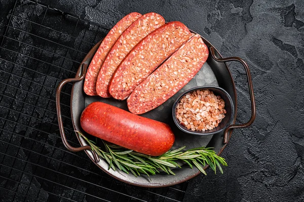 stock image Turkish Sliced Sucuk beef meat sausage ready for cooking. Black background. Top view.