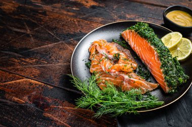 Cured Salmon fillet with dill, salt and papper, gravlax. Wooden background. Top view. Copy space.