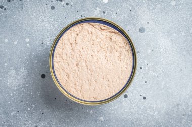 Can of Cod liver, natural source of omega 3. Gray background. Top view. Copy space.