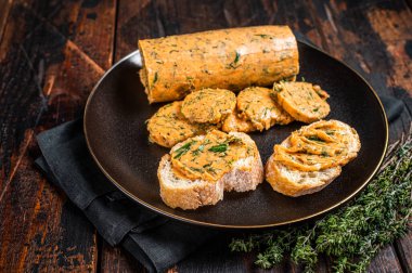 Butter with flavoring additives, sandwich butter with fresh herbs, sweet peppers, lemon, onion, garlic. Wooden background. Top view.