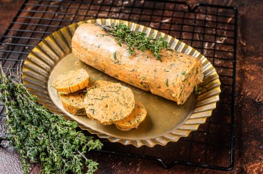 Homemade Herb Butter with thyme. Dark background. Top view.