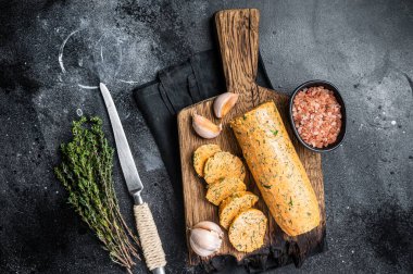 Healthy butter with dill, parsley and garlic. Black background. Top view.