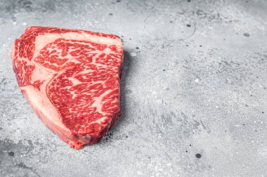 Japanese wagyu rib eye beef meat steak. Gray background. Top view. Copy space.