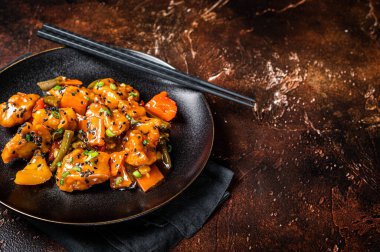 Chinese cuisine sweet and sour pork guo bao rou. Dark background. Top view. Copy space.