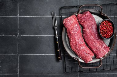 Raw lamb tenderloin Fillet, Mutton Sirloin Meat. Black background. Top view. Copy space.