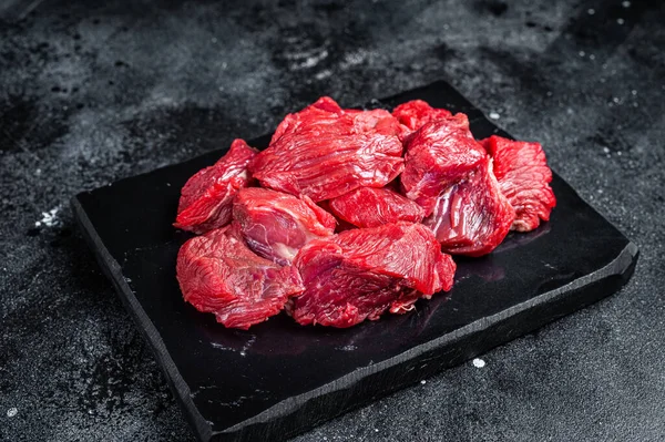 Fresh Raw diced beef veal meat for cooking Shish kebab. Black background. Top view.
