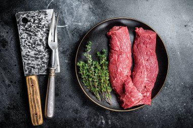 Halal fresh lamb tenderloin meat, Mutton sirloin fillet with thyme. Black background. Top view.