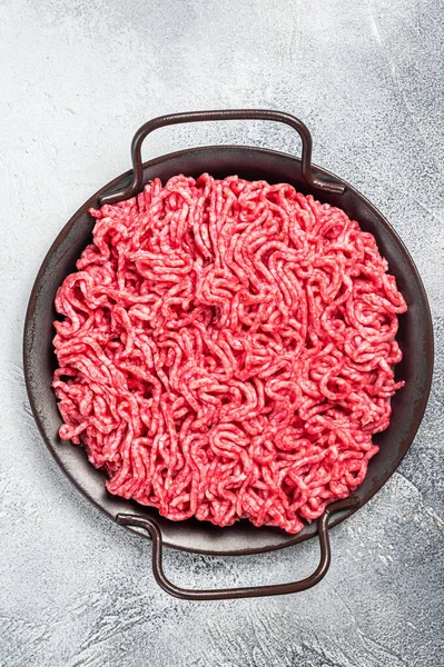 Raw Mince Ground meat in a kitchen tray. White background. Top view.