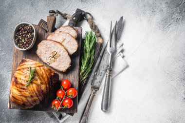 Sliced Rolled meatloaf, ground meat loaf with bacon. White background. Top view. Copy space.