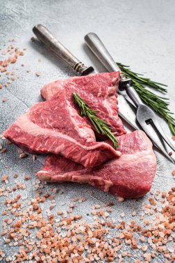 Silverside sirloin beef cut, raw meat on butcher table with herbs. White background. Top view.