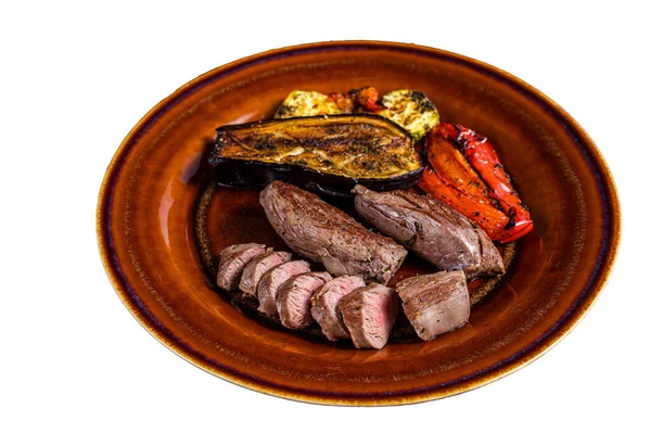 Grilled mutton tenderloin Fillet Meat, lamb sirloin on rustic plate with vegetables. Isolated on white background.