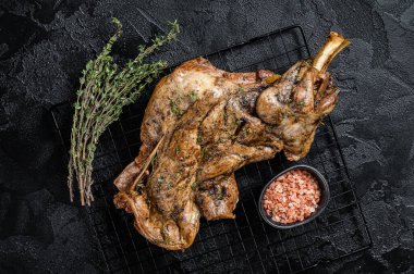 Barbecue Roasted lamb mutton shoulder meat with herbs and spices. Black background. Top view.