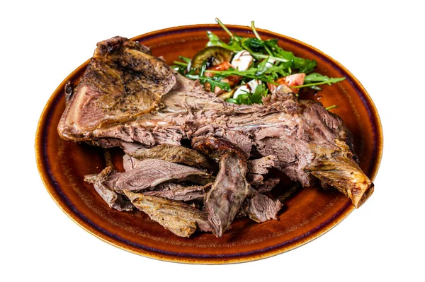 stock image Grilled goat or lamb mutton shoulder meat in a rustic plate with salad. Isolated on white background