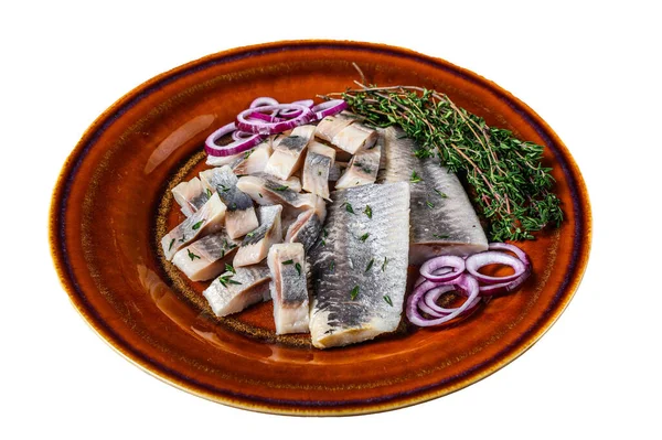 Pickled marinated herring fish sliced fillet on a plate with thyme and onion. Isolated on white background