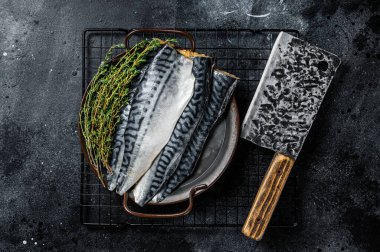 Raw Fresh fillet mackerel fish. Black background. Top view.
