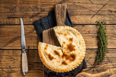 Kubdari Bread, Tasty Flat Bread Stuffed with Spiced meat. Wooden background. Top view.