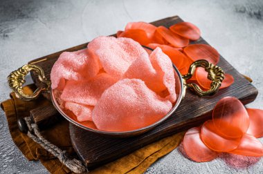Cooking kerupuk or prawn shrimp crackers, chips. White background. Top view.